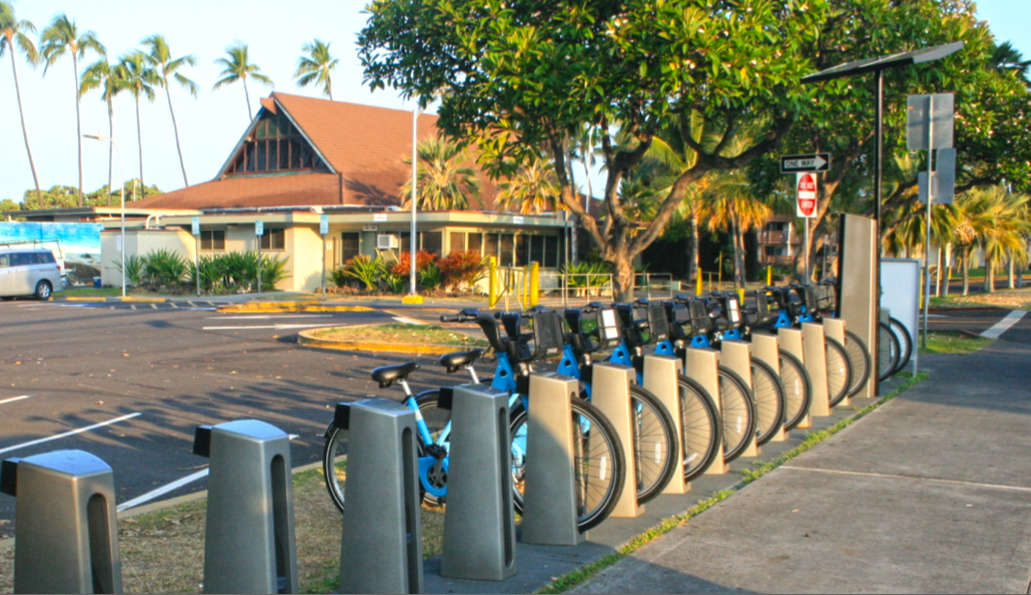 Blue HIBIKE bicycles lined up at the Hale Halawai docking station in Kailua-Kona