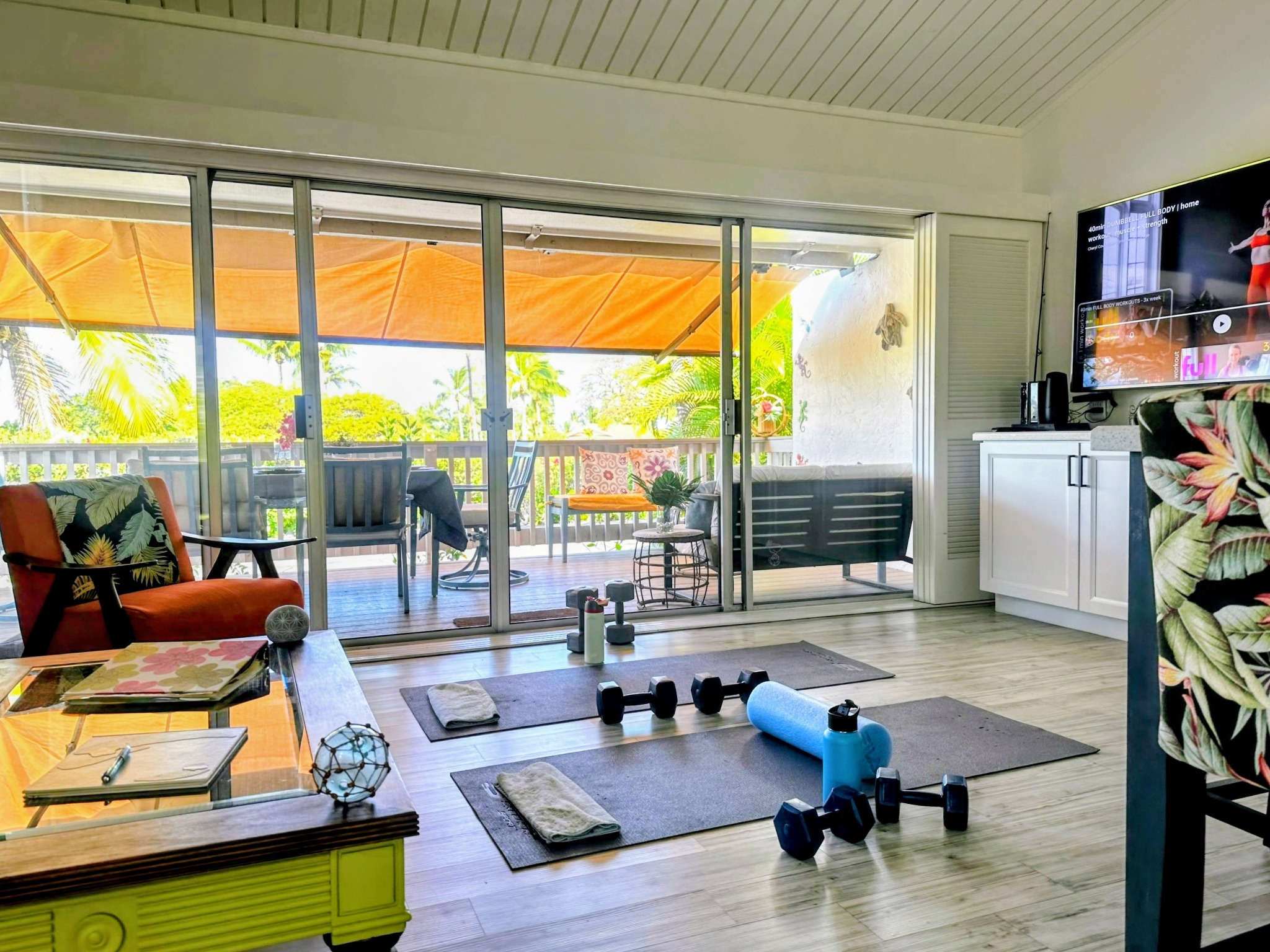 Workout equipment arranged in the living room overlooking the lanai